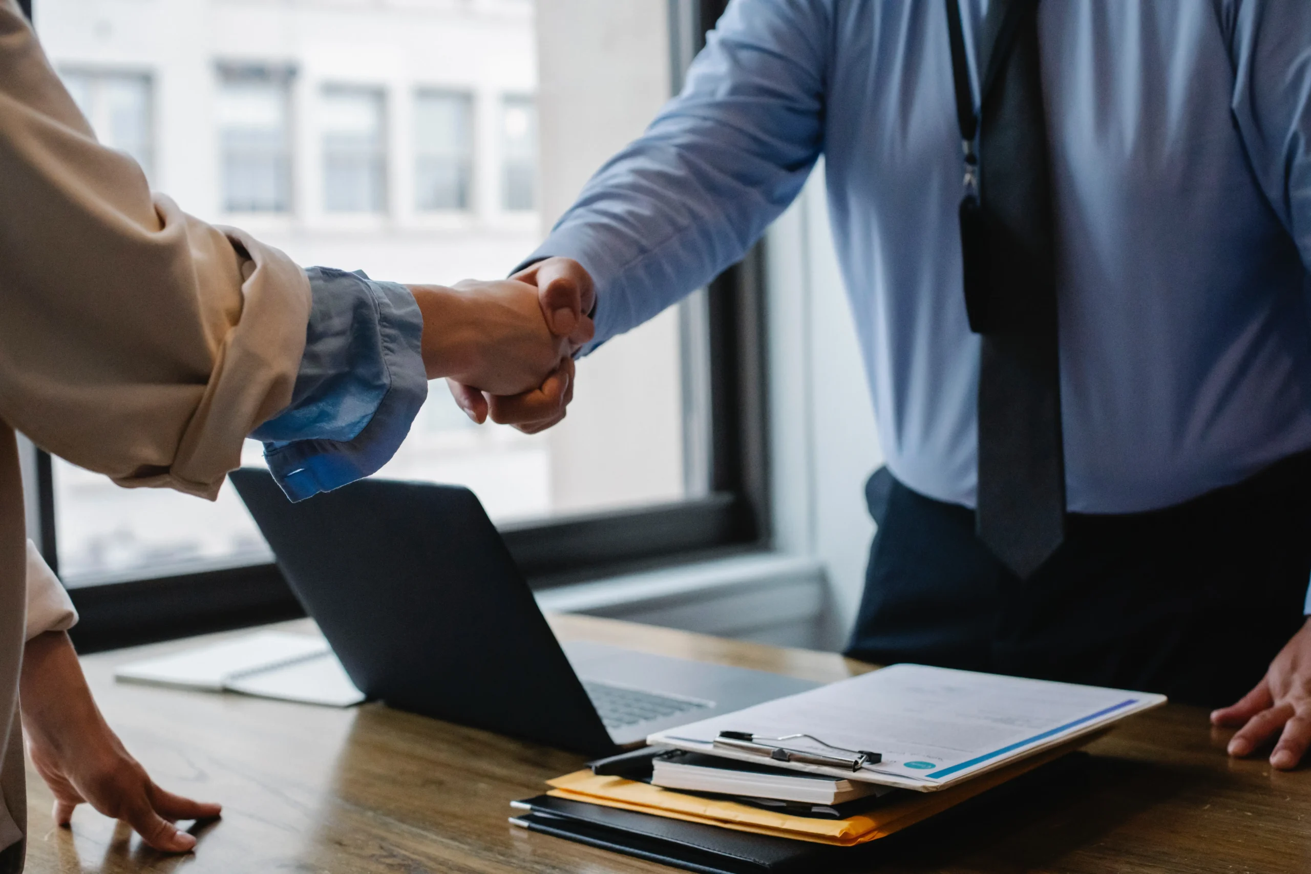 The image is showing two person shaking hand