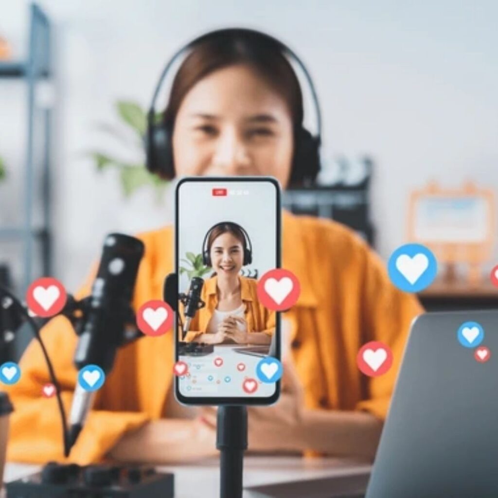 Digital marketer conducting a live stream on a mobile phone, promoting dynamic online marketing services and interactive digital marketing packages.