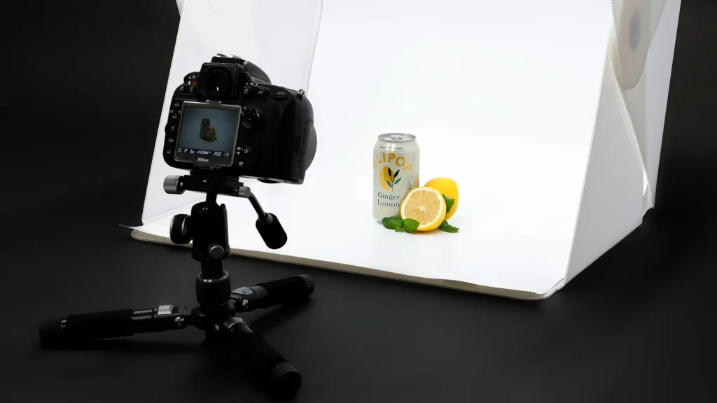 Camera taking a product shot in a photo studio setup, promoting Digital Marketing Services and social media packages that require premium imagery.